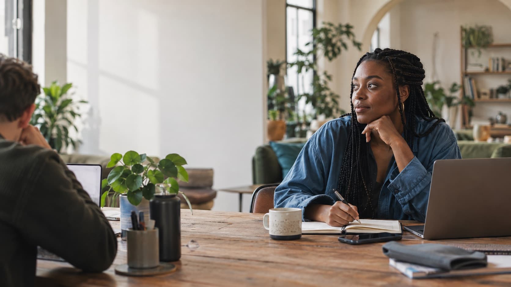 Illustrative scene of a woman listening to someone across a shared table